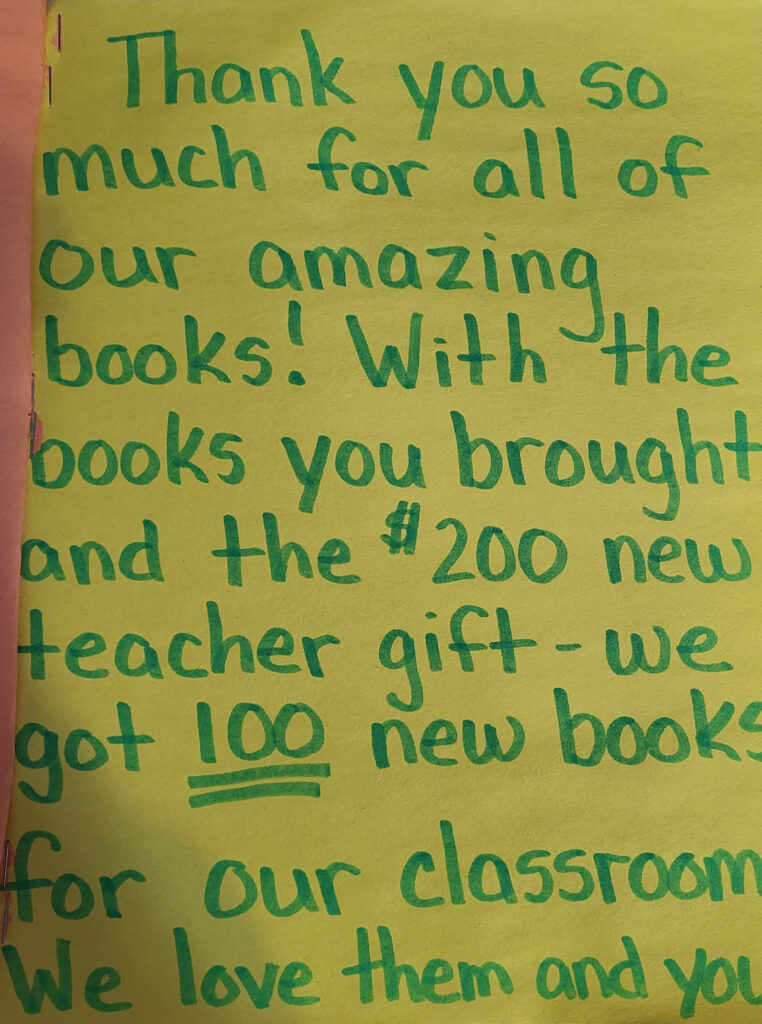 a thank you card that says, "thank you so much for all of our amazing books! with the books you brought and the 0 new teacher gift- we got 100 books for our classroom we love them and you.